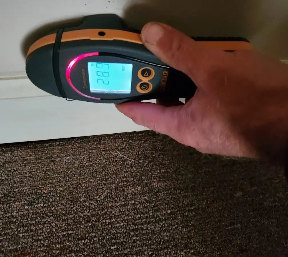 Moisture detection at baseboard during Storm Damage Restoration in Borger